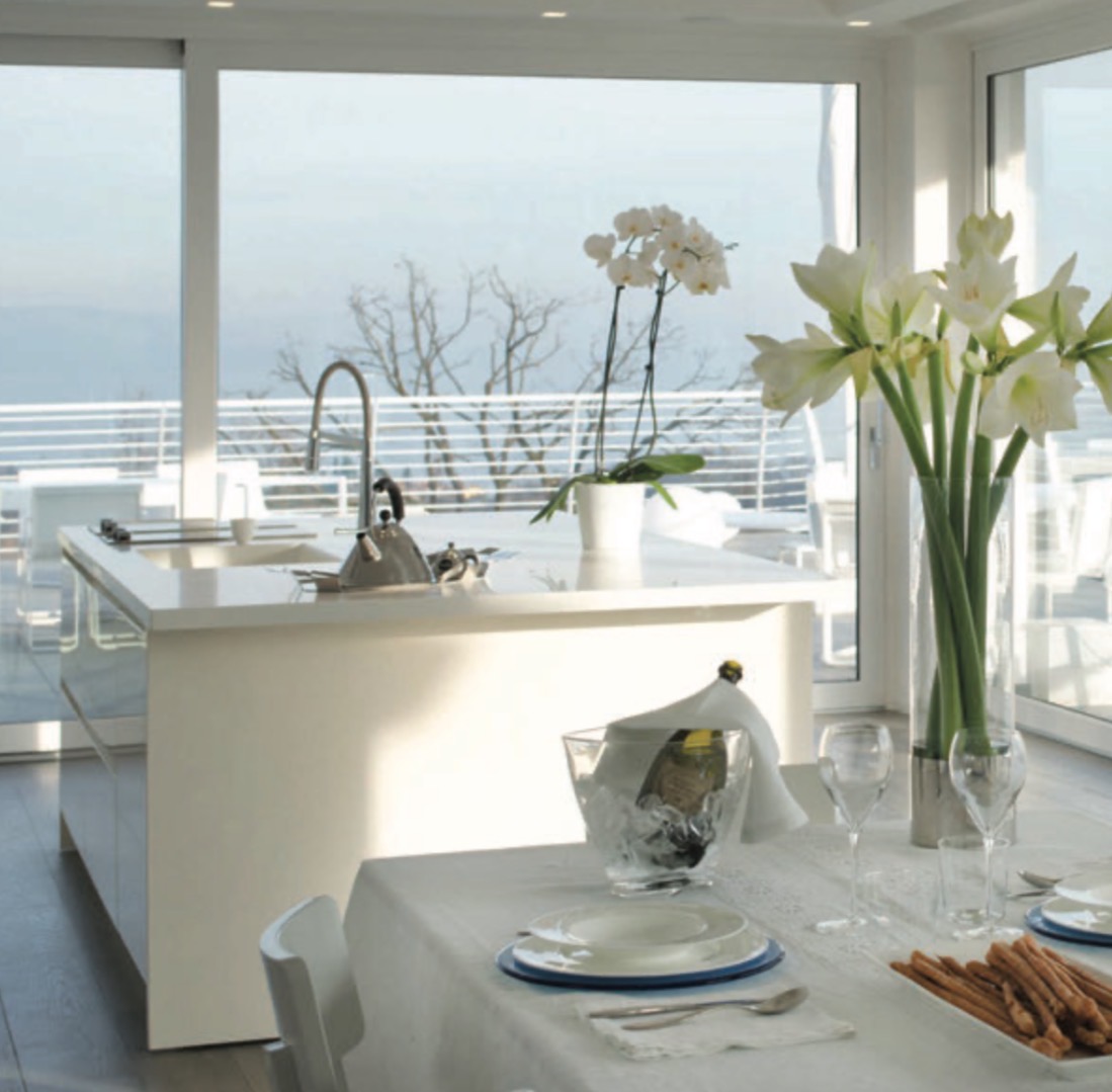 Luxury Penthouse with Lake View – Padenghe sul Garda Luxury penthouse dining area with panoramic lake view in Padenghe sul Garda, Lake Garda luxury real estate by MiruVision Real Estate